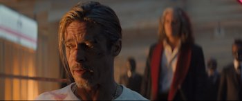 Movie still from “Bullet Train” (2022), directed by David Leitch – A person wearing a white t shirt; Close Up shot, Over the shoulder angle