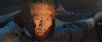 Movie still from “Bullet Train” (2022), directed by David Leitch – A person with blood on his face; Close Up shot, Low angle