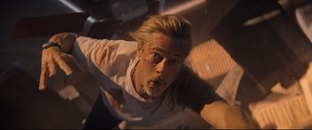 Movie still from “Bullet Train” (2022), directed by David Leitch – A man in a white shirt is flying through the air; Medium shot, Overhead angle