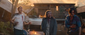 Movie still from “Bullet Train” (2022), directed by David Leitch – An old man with blood all over his face; Medium shot, Over the shoulder angle