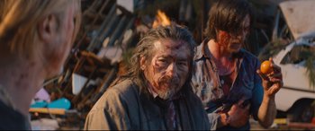 Movie still from “Bullet Train” (2022), directed by David Leitch – An old man with blood all over his face; Medium shot, Over the shoulder angle
