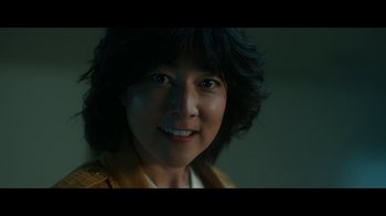 Movie still from “The Midnight Club” (2022), created by Mike Flanagan – A person smiling for the camera; Close Up shot, Low angle