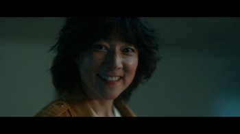 Movie still from “The Midnight Club” (2022), created by Mike Flanagan – A person smiling for the camera; Close Up shot, Low angle