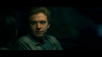 Movie still from “The Midnight Club” (2022), created by Mike Flanagan – A man in a green shirt is in the dark; Close Up shot, Over the shoulder angle