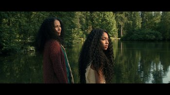 Movie still from “The Midnight Club” (2022), created by Mike Flanagan – Two women standing next to each other near a body of water; Medium shot, Low angle