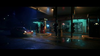 Movie still from “The Midnight Club” (2022), created by Mike Flanagan – A gas station at night with a car parked in front of it; Extreme Wide shot, High angle