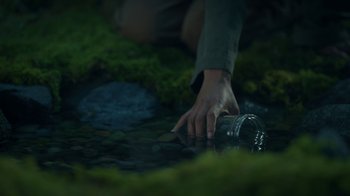 Movie still from “The Midnight Club” (2022), created by Mike Flanagan – A person holding a water bottle in the grass; Extreme Close Up shot, High angle