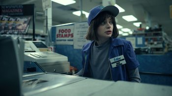 Movie still from “The Midnight Club” (2022), created by Mike Flanagan – A woman wearing a blue jacket and a blue hat; Medium shot, Low angle