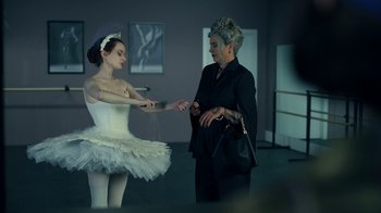 Movie still from “The Midnight Club” (2022), created by Mike Flanagan – A woman and a girl in a white tutu; Medium shot, Over the shoulder angle
