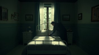 Movie still from “The Midnight Club” (2022), created by Mike Flanagan – A man standing on a bed in front of a window; Wide shot, Low angle