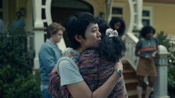 Movie still from “The Midnight Club” (2022), created by Mike Flanagan – Two people hugging each other in front of a building; Medium shot, Over the shoulder angle