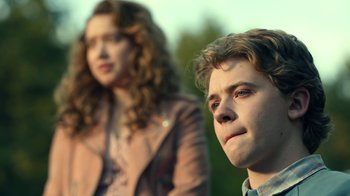 Movie still from “The Midnight Club” (2022), created by Mike Flanagan – A man and a woman standing next to each other; Close Up shot, Over the shoulder angle