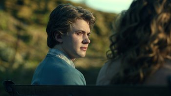 Movie still from “The Midnight Club” (2022), created by Mike Flanagan – A young man is looking into the distance; Close Up shot, Over the shoulder angle