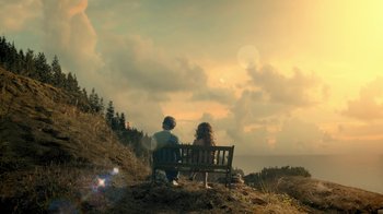 Movie still from “The Midnight Club” (2022), created by Mike Flanagan – A man and woman sitting on top of a wooden bench; Extreme Wide shot, High angle