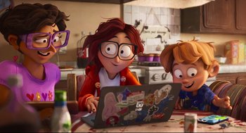 Movie still from “The Mitchells vs the Machines” (2021), directed by Jeff Rowe – A woman sitting in front of a laptop computer on top of a table; Wide shot, Over the shoulder angle