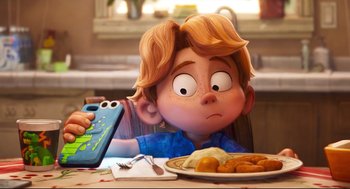 Movie still from “The Mitchells vs the Machines” (2021), directed by Jeff Rowe – A cartoon boy sitting at a table with a plate of food in front of him; Close Up shot, Over the shoulder angle