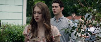 Movie still from “The Mule” (2018), directed by Clint Eastwood – A young woman and a young man standing next to each other in front of trees; Close Up shot, Over the shoulder angle