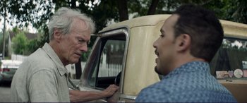 Movie still from “The Mule” (2018), directed by Clint Eastwood – Two men standing next to an old truck; Close Up shot, Over the shoulder angle
