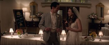 Movie still from “The Mule” (2018), directed by Clint Eastwood – A man and a woman are holding wine glasses; Medium shot, Over the shoulder angle