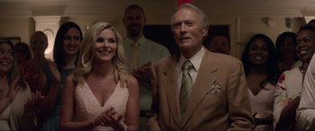 Movie still from “The Mule” (2018), directed by Clint Eastwood – A man and a woman standing next to each other in a room; Close Up shot, Over the shoulder angle