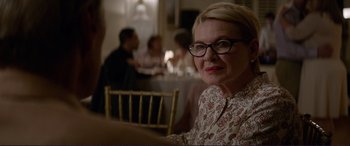 Movie still from “The Mule” (2018), directed by Clint Eastwood – An older woman wearing glasses sitting at a table; Close Up shot, Over the shoulder angle