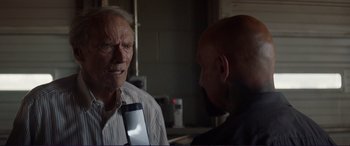 Movie still from “The Mule” (2018), directed by Clint Eastwood – An older man talking to a younger man in a kitchen; Close Up shot, Over the shoulder angle