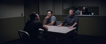 Movie still from “The Mule” (2018), directed by Clint Eastwood – A group of men sitting at a table talking to each other; Medium shot, Over the shoulder angle
