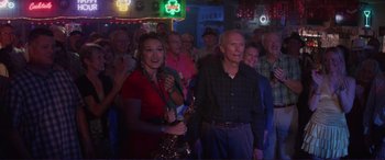 Movie still from “The Mule” (2018), directed by Clint Eastwood – A group of people standing in a room; Medium shot, Over the shoulder angle