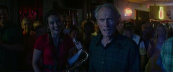 Movie still from “The Mule” (2018), directed by Clint Eastwood – An old man and a woman are standing in a room; Close Up shot, Low angle