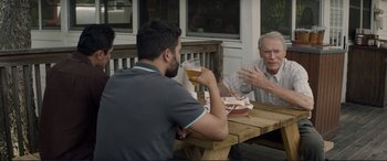 Movie still from “The Mule” (2018), directed by Clint Eastwood – A group of men sitting at a table drinking beer; Medium shot, Over the shoulder angle
