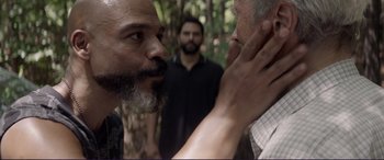 Movie still from “The Mule” (2018), directed by Clint Eastwood – A man with a gray beard is touching another man's face; Close Up shot, Over the shoulder angle