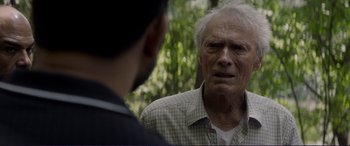 Movie still from “The Mule” (2018), directed by Clint Eastwood – An older man talking to a younger man in front of a forest; Close Up shot, Over the shoulder angle