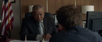 Movie still from “The Mule” (2018), directed by Clint Eastwood – A man sitting in front of another man in a suit; Close Up shot, Over the shoulder angle