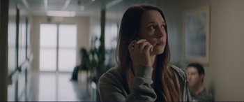 Movie still from “The Mule” (2018), directed by Clint Eastwood – A woman holding a cell phone up to her ear; Close Up shot, Low angle