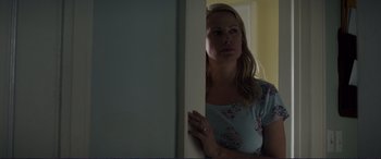 Movie still from “The Mule” (2018), directed by Clint Eastwood – A woman leaning against a wall in a room; Medium shot, Over the shoulder angle