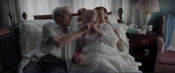 Movie still from “The Mule” (2018), directed by Clint Eastwood – An older man and a younger woman sitting in a bed; Medium shot, Over the shoulder angle