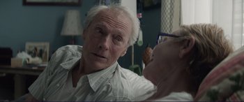 Movie still from “The Mule” (2018), directed by Clint Eastwood – An older man looking into a mirror while holding a phone; Close Up shot, Over the shoulder angle