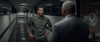 Movie still from “The Mule” (2018), directed by Clint Eastwood – A man standing next to another man in front of a mirror; Medium shot, Over the shoulder angle