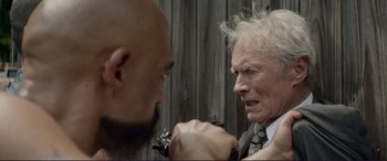 Movie still from “The Mule” (2018), directed by Clint Eastwood – A bald man and an older man face each other; Close Up shot, Over the shoulder angle