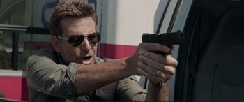 Movie still from “The Mule” (2018), directed by Clint Eastwood – A person holding a gun; Close Up shot, Over the shoulder angle
