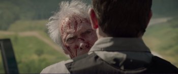 Movie still from “The Mule” (2018), directed by Clint Eastwood – An old man with a bloody face and a young man with white hair looking at him; Close Up shot, Over the shoulder angle