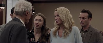 Movie still from “The Mule” (2018), directed by Clint Eastwood – Two women standing next to each other in front of a crowd; Close Up shot, Over the shoulder angle