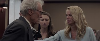 Movie still from “The Mule” (2018), directed by Clint Eastwood – Two women and an older man are talking to each other; Close Up shot, Over the shoulder angle