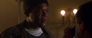 Movie still from “The Negotiator” (1998), directed by F. Gary Gray – A person holding a cell phone; Close Up shot, Low angle