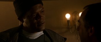 Movie still from “The Negotiator” (1998), directed by F. Gary Gray – A person with a light in the background; Close Up shot, Low angle