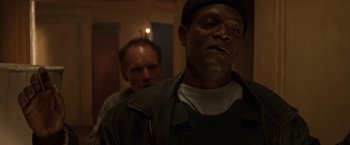 Movie still from “The Negotiator” (1998), directed by F. Gary Gray – Two men standing next to each other in a room; Close Up shot, Low angle