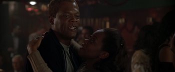 Movie still from “The Negotiator” (1998), directed by F. Gary Gray – A man and a woman are hugging in a dark room; Close Up shot, Low angle