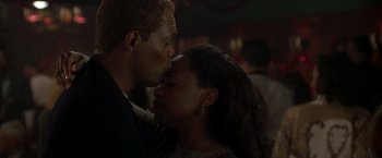 Movie still from “The Negotiator” (1998), directed by F. Gary Gray – A man and a woman are kissing in a room; Close Up shot, Low angle