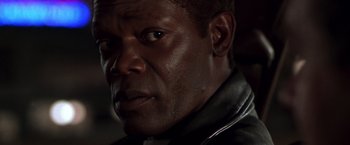 Movie still from “The Negotiator” (1998), directed by F. Gary Gray – A person wearing a leather jacket; Close Up shot, Over the shoulder angle