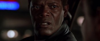 Movie still from “The Negotiator” (1998), directed by F. Gary Gray – A man's face in a dark room; Close Up shot, Low angle